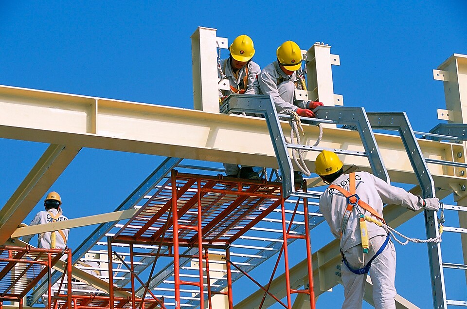 Construction workers building a facility to apply the OMEGA process