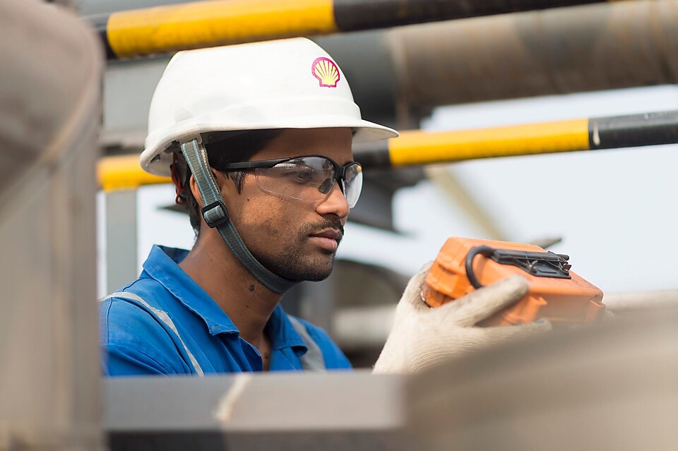 Employee conducts hydrotreating inspection at the top of an LNG tank